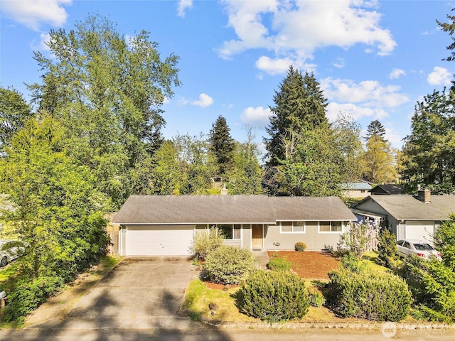 single story home featuring a garage and concrete driveway