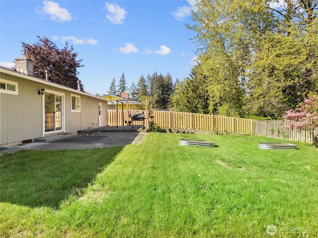 view of yard featuring fence and a patio