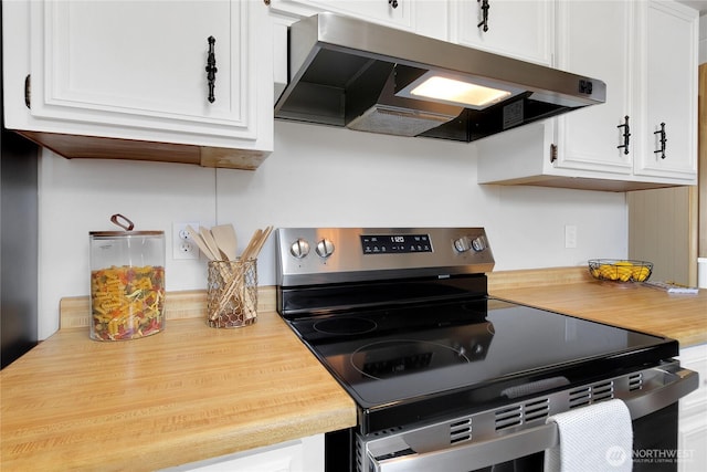 22018 28th Pl S Unit 5, Des Moines, WA 98198 - kitchen with wooden counters, under cabinet range hood, white cabinetry, and electric stove