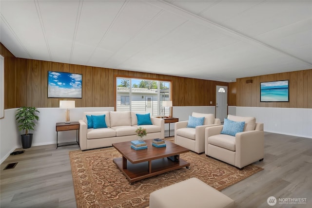 22018 28th Pl S Unit 5, Des Moines, WA 98198 - living area featuring visible vents, baseboards, wood finished floors, and wooden walls