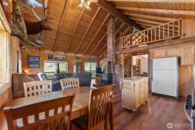 364 E Chewuch Rd, Winthrop, WA 98862 - dining area with a wood ceiling with exposed beams, a wood stove, high vaulted ceiling, wood walls, and dark wood-style flooring