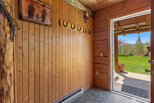 interior space featuring wood walls, wooden ceiling, and a baseboard radiator