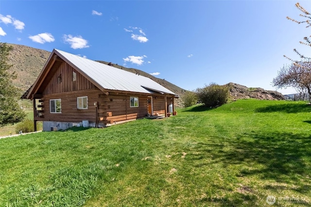 view of property exterior featuring a lawn and log exterior