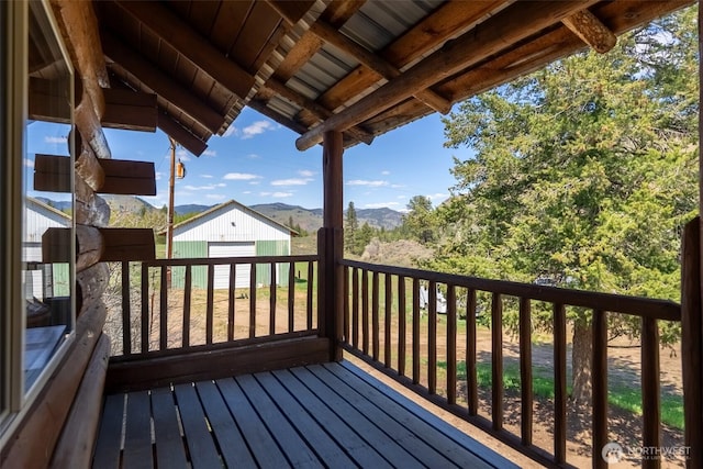 wooden deck with a mountain view and an outdoor structure