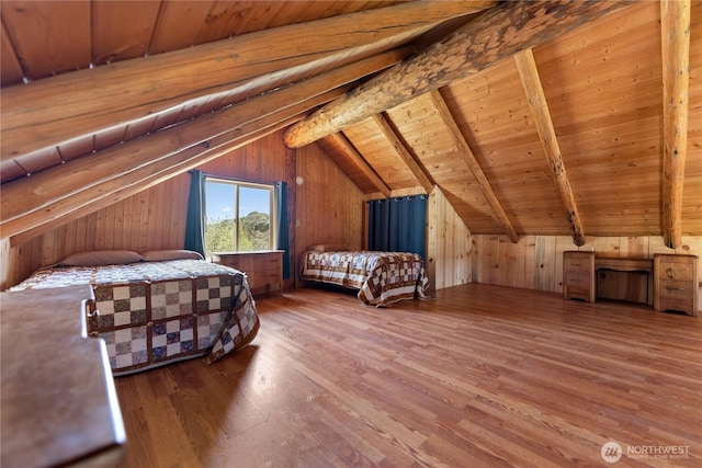 bedroom with wooden walls, wooden ceiling, vaulted ceiling with beams, and wood finished floors