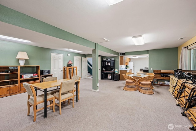 dining space featuring light colored carpet and visible vents
