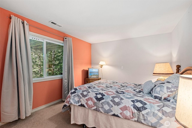 carpeted bedroom with baseboards and visible vents