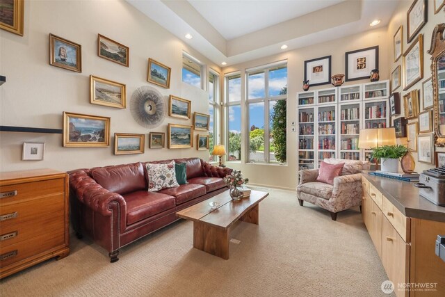 living area featuring recessed lighting, baseboards, and light colored carpet