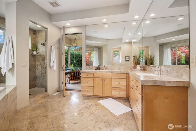 full bathroom with a walk in shower, recessed lighting, visible vents, and a sink