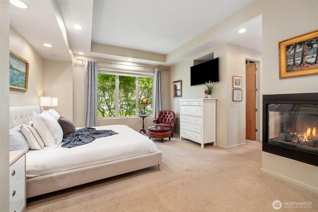 bedroom featuring light colored carpet, recessed lighting, a multi sided fireplace, and baseboards