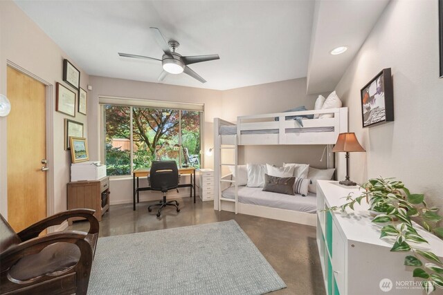bedroom with finished concrete floors, a ceiling fan, and baseboards