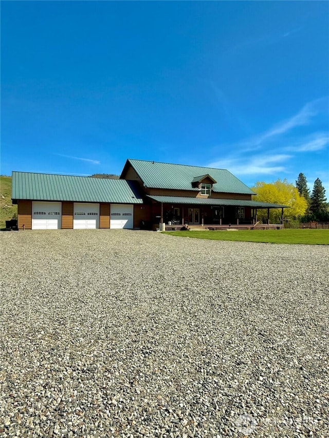view of front facade with metal roof and a garage