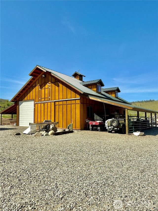 view of home's exterior featuring a carport, board and batten siding, and metal roof