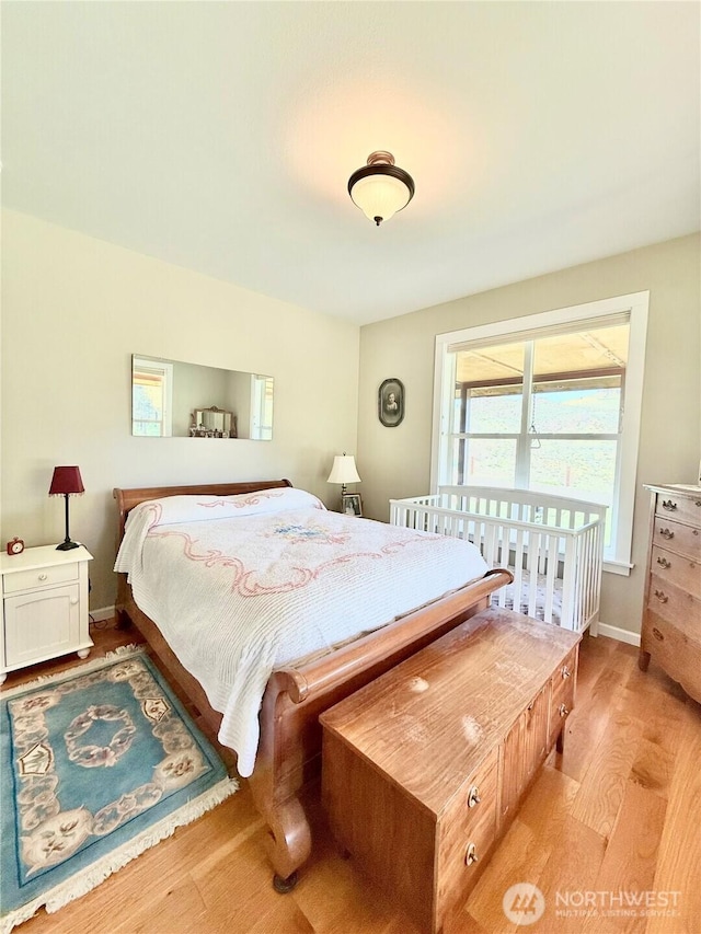 bedroom featuring baseboards and light wood-style floors