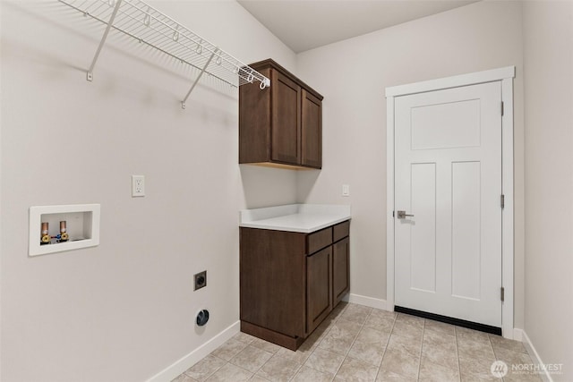 washroom featuring cabinet space, hookup for an electric dryer, baseboards, and washer hookup