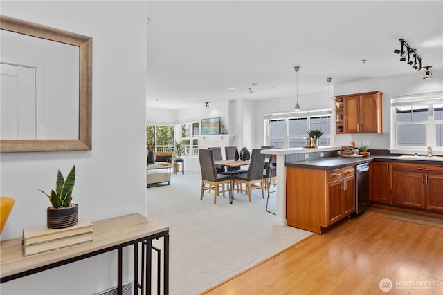 kitchen featuring brown cabinetry, open shelves, a sink, and dishwasher