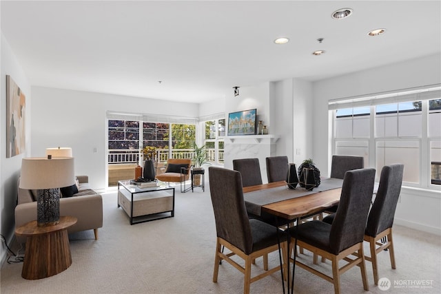 dining area with recessed lighting, light colored carpet, and plenty of natural light