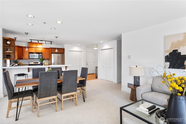 dining room with baseboards, light carpet, and recessed lighting
