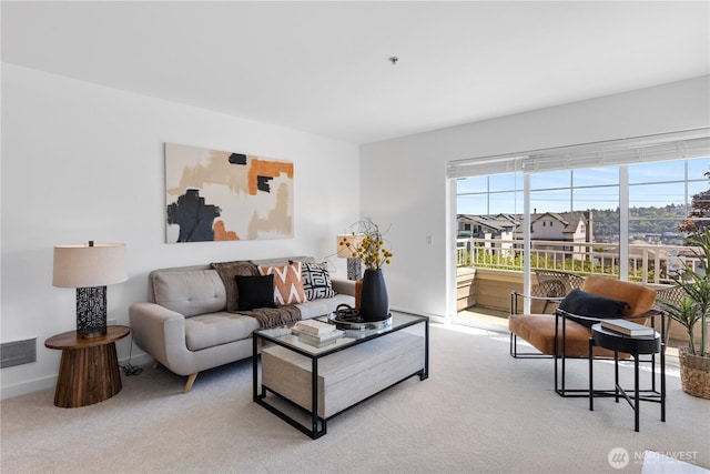 living area featuring visible vents, carpet flooring, and baseboards