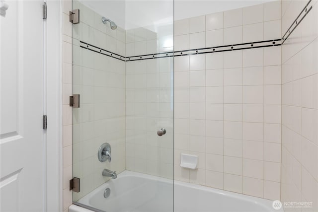 bathroom with shower / bath combination with glass door