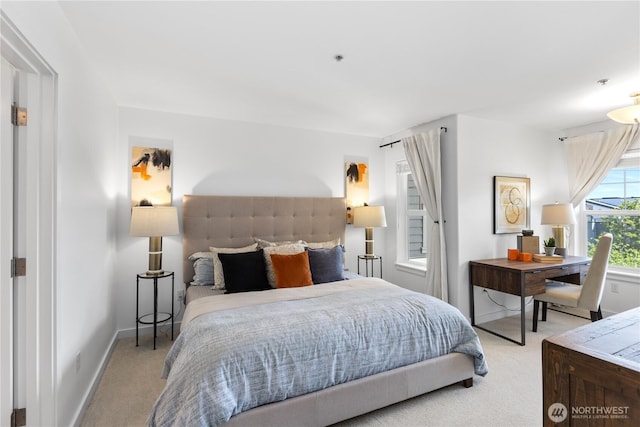 bedroom featuring baseboards and light carpet