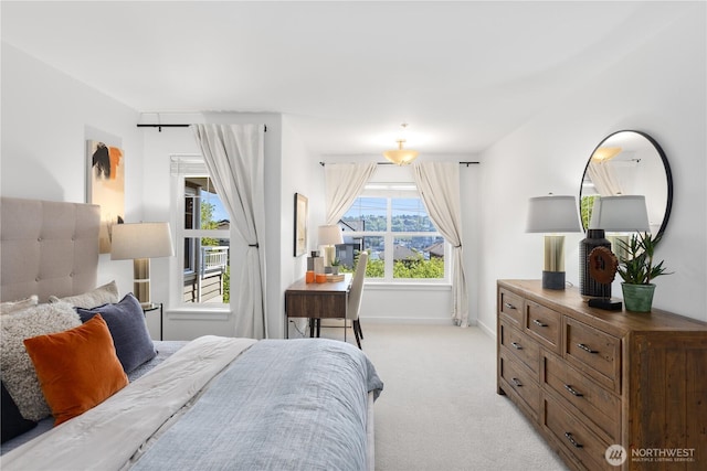 bedroom featuring light colored carpet and baseboards
