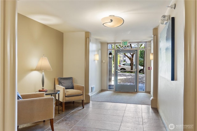 carpeted entrance foyer with baseboards