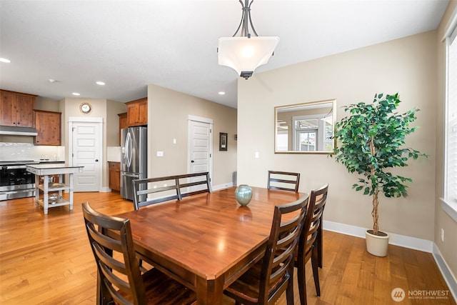 dining space with recessed lighting, baseboards, and light wood-style floors