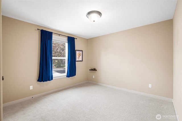 unfurnished room with baseboards and carpet
