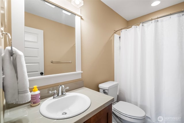 full bathroom with toilet, curtained shower, and vanity