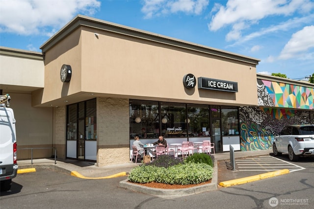 view of building exterior featuring uncovered parking