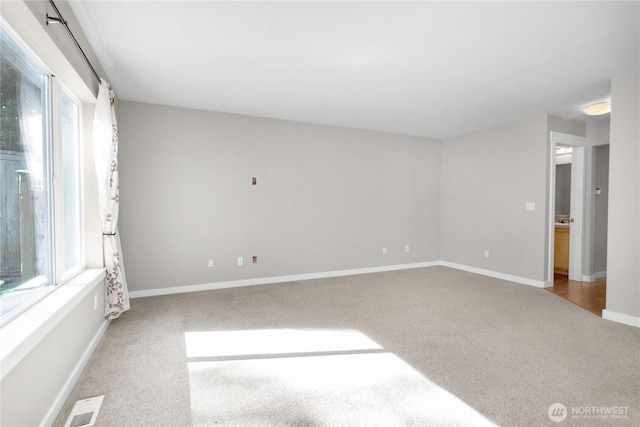 spare room with carpet flooring and baseboards