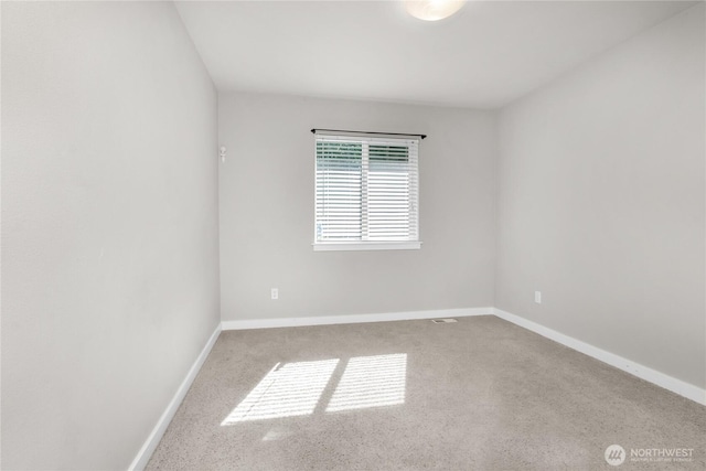 carpeted spare room with baseboards
