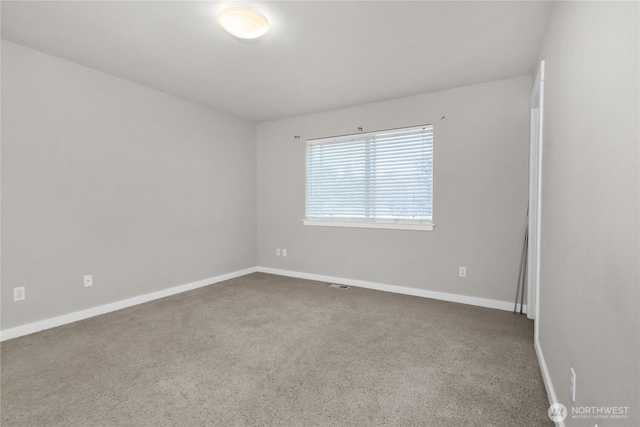 carpeted spare room with baseboards