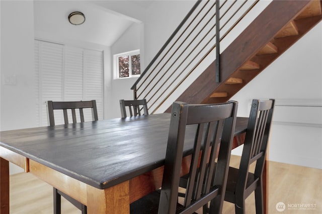 9624 SW Gorsuch Rd, Vashon, WA 98070 - dining area with wood finished floors, stairs, and vaulted ceiling