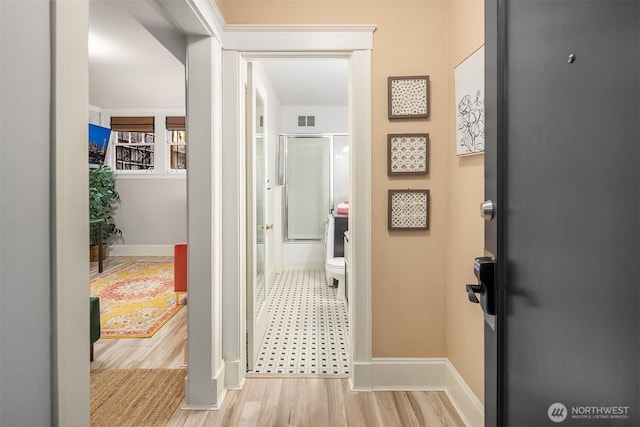 2132 5th Ave Unit 008, Seattle, WA 98121 - corridor featuring baseboards, wood finished floors, and visible vents