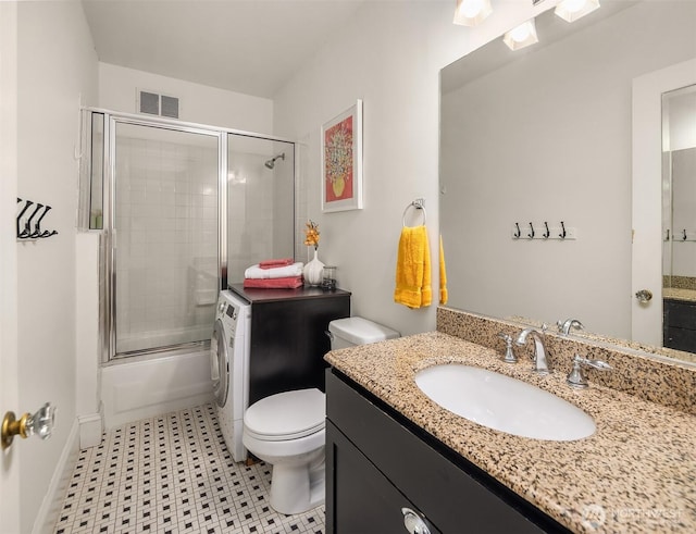 2132 5th Ave Unit 008, Seattle, WA 98121 - full bath with visible vents, vanity, shower / bath combination with glass door, toilet, and washer / clothes dryer