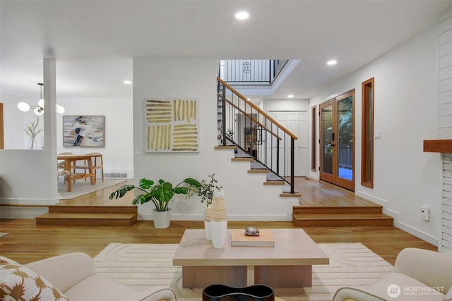 living room with wood finished floors, stairs, recessed lighting, and baseboards