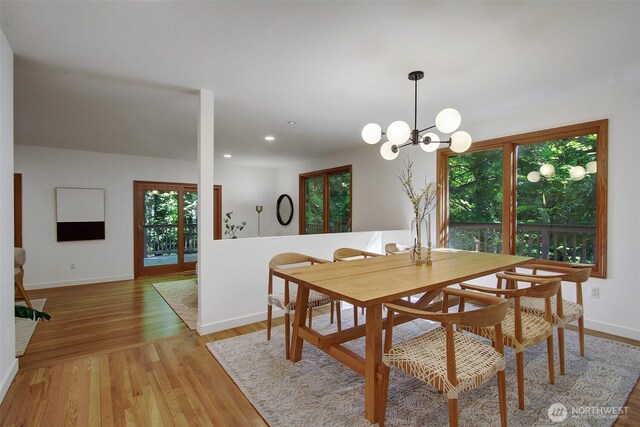 dining room featuring baseboards, light wood-style floors, a chandelier, and recessed lighting