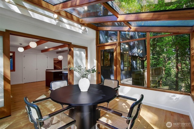 sunroom featuring beam ceiling