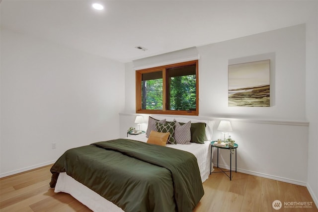 bedroom featuring wood finished floors, baseboards, and recessed lighting