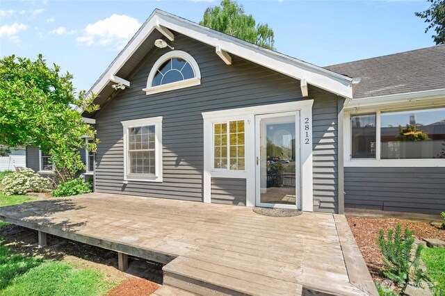 back of property featuring a deck