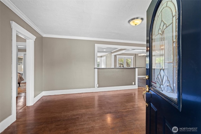 entrance foyer with crown molding, baseboards, and wood finished floors