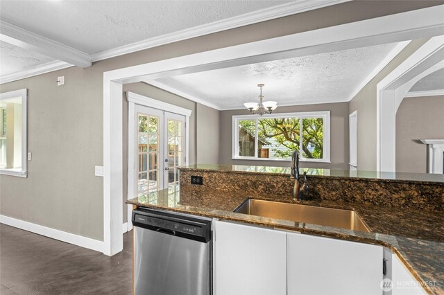 kitchen featuring dishwasher, a sink, baseboards, dark wood-type flooring, and a wealth of natural light