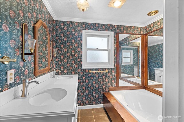 full bath featuring a sink, baseboards, tile patterned floors, and a bath