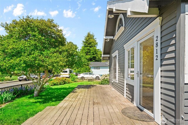 wooden terrace with a lawn