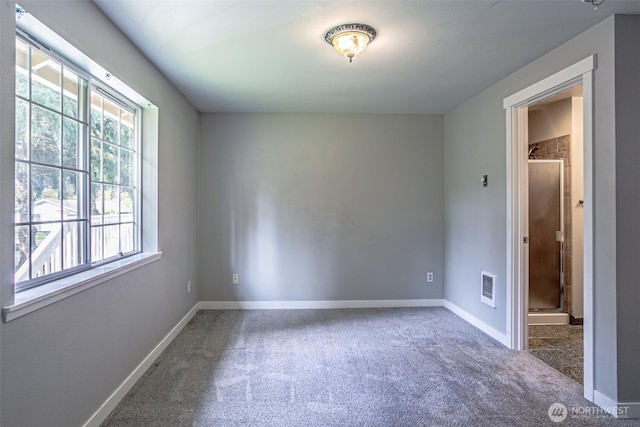 spare room with baseboards, carpet, and visible vents