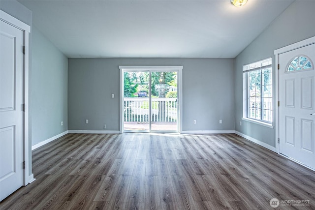 entrance foyer with baseboards, dark wood finished floors, and lofted ceiling