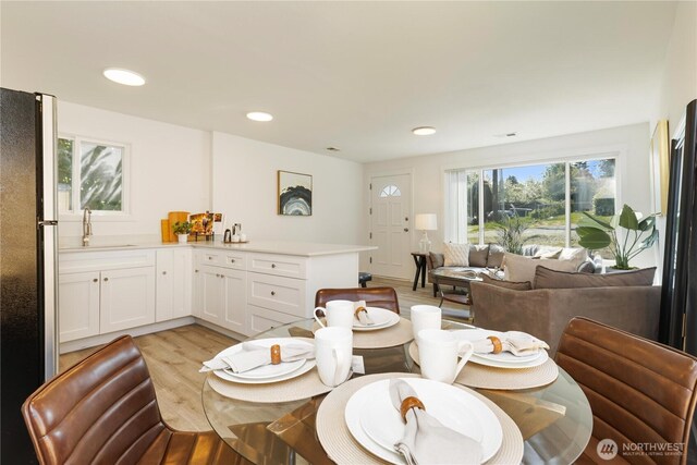dining area with recessed lighting and light wood-style flooring
