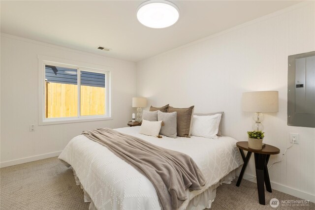 bedroom featuring carpet floors, baseboards, electric panel, and visible vents